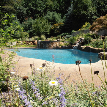 Upper Saucon Township custom built pool with raised spa, waterfall, & boulders