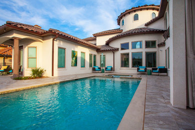 Inspiration for a large mediterranean backyard tile and rectangular lap hot tub remodel in Dallas