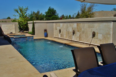 Hot tub - small contemporary backyard stamped concrete and rectangular hot tub idea in Sacramento