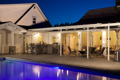 Inspiration for a mid-sized contemporary backyard stamped concrete and rectangular natural pool remodel in Vancouver