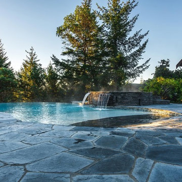 Vanishing Edge Concrete pool with spa and water feature