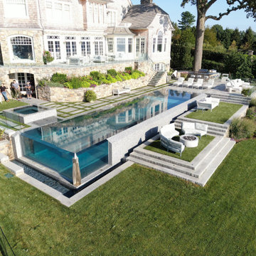 vanishing edge glass wall pool + raised perimeter overflow spa