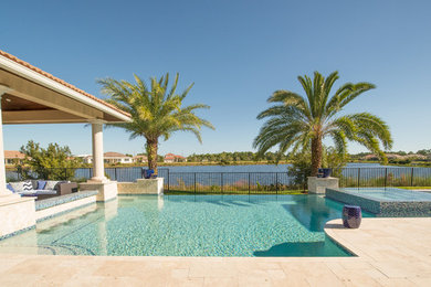 Pool - mid-sized modern backyard stone and custom-shaped infinity pool idea in Miami