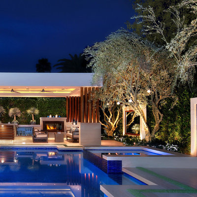 Inspiration for a contemporary backyard tile and custom-shaped infinity pool remodel in Orange County