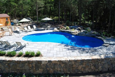 Pool fountain - large traditional backyard stamped concrete and custom-shaped lap pool fountain idea in New York
