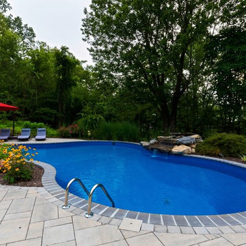Vinyl pool with Waterfall, Landscape Lighting and Landscaping
