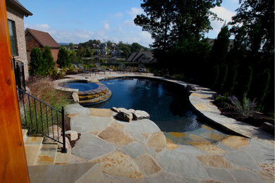 Inspiration for a large rustic backyard stone and custom-shaped lap hot tub remodel in Other