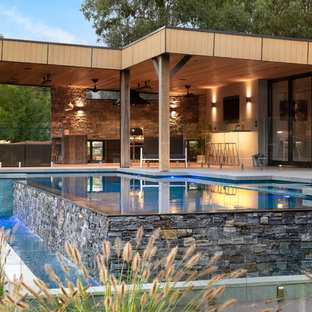 Inspiration for a contemporary backyard custom-shaped infinity pool in Melbourne with a hot tub and concrete slab.
