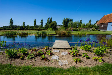 Design ideas for a large country back rectangular natural swimming pool in Seattle.