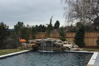 Example of a large arts and crafts backyard concrete and rectangular lap pool fountain design in Boise