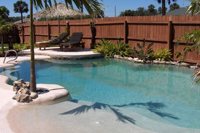Example of a beach style pool design in Dallas