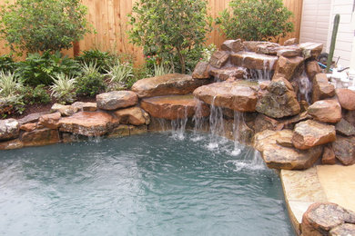 Mountain style stamped concrete and custom-shaped pool fountain photo in Houston