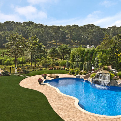 Example of a classic backyard custom-shaped pool design in New York