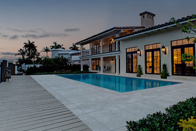 Inspiration for a coastal backyard custom-shaped pool remodel in Miami
