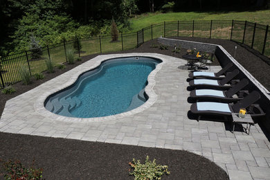 Large elegant backyard stone and custom-shaped natural pool fountain photo in New York