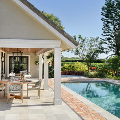 Example of a mid-sized transitional backyard concrete paver and rectangular lap pool design