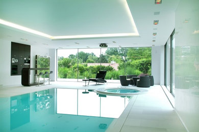 Photo of a contemporary indoor rectangular hot tub in Cologne.