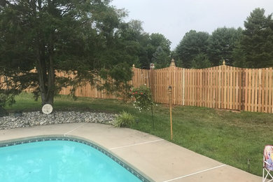 Mid-sized elegant backyard concrete and rectangular lap pool photo in Philadelphia