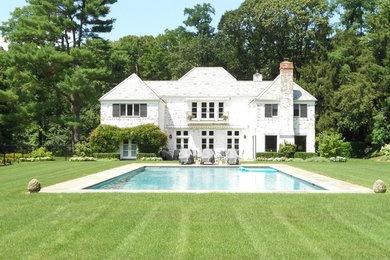 Inspiration for a large timeless backyard stone and rectangular lap pool remodel in New York