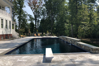 Example of a mid-sized mountain style tile and rectangular pool design in DC Metro