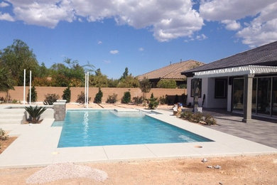 Hot tub - large contemporary backyard concrete paver and rectangular lap hot tub idea in Las Vegas