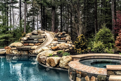 Inspiration for a medium sized rustic back custom shaped natural hot tub in Boston with stamped concrete.
