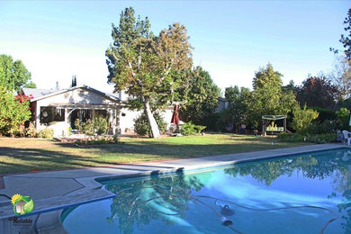 Large elegant backyard concrete and rectangular pool photo in Los Angeles