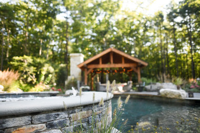 Pool - large craftsman backyard pool idea in Boston