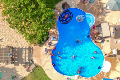 Island style backyard custom-shaped pool photo in Other