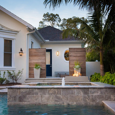 Inspiration for a contemporary backyard tile and custom-shaped pool fountain remodel in Tampa