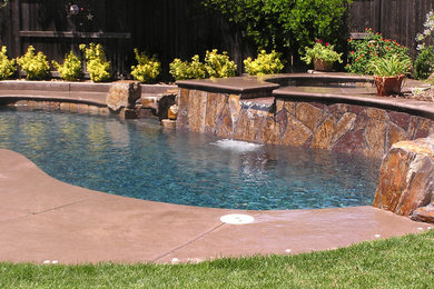 Imagen de piscinas y jacuzzis clásicos pequeños a medida en patio trasero con adoquines de piedra natural