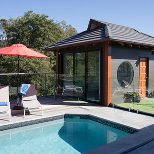 Photo of a mid-sized asian backyard rectangular lap pool in Brisbane with a pool house.