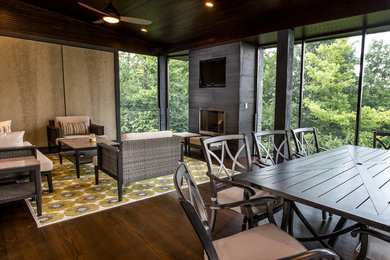 Mid-sized transitional porch idea in Cincinnati with a fire pit and a roof extension