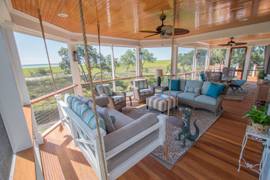 This is an example of a mid-sized coastal back porch design in Charleston with decking and a roof extension.