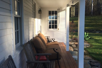 Inspiration for a large cottage front porch remodel in Burlington with a roof extension