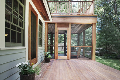 Mid-sized trendy screened-in back porch photo in Other with decking and a roof extension