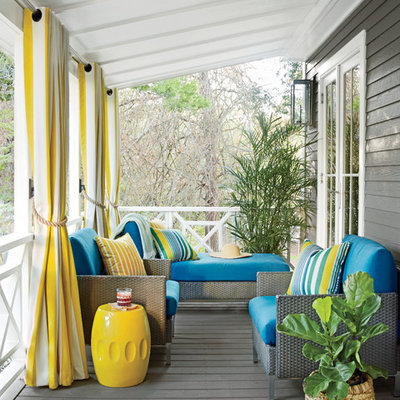 Inspiration for a mid-sized coastal front porch remodel in Miami with decking and a roof extension
