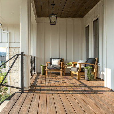This is an example of a large cottage front porch design in Portland with decking and a roof extension.