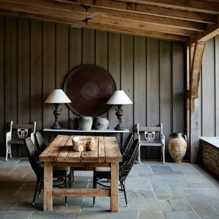 Foto di un patio o portico country di medie dimensioni e dietro casa con pavimentazioni in pietra naturale e un tetto a sbalzo