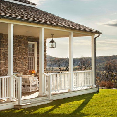 Farmhouse back porch idea in New York with decking and a roof extension