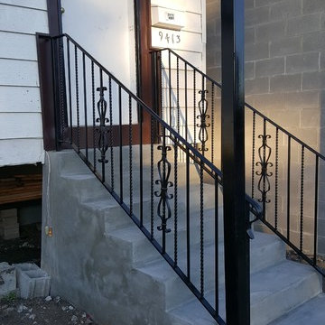AFTER PHOTO Front Porch wood to concrete with wrought iron hand rails