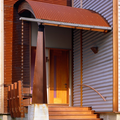 Eclectic porch idea in New York with decking and a roof extension