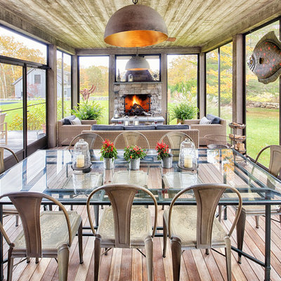 Large country screened-in porch idea in Burlington with decking and a roof extension