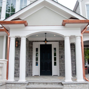 Huge eclectic stamped concrete porch idea in Nashville with a roof extension