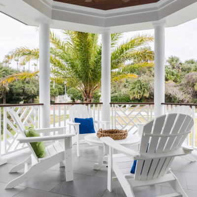 Mid-sized beach style tile back porch idea in Jacksonville with a roof extension