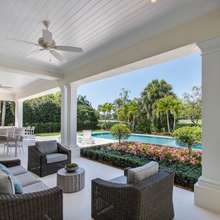 Inspiration for a mediterranean porch remodel in Miami with a roof extension