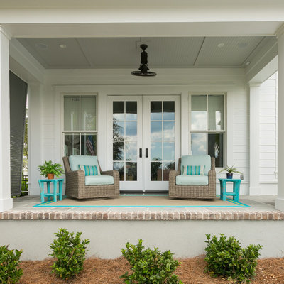 Beach style porch photo in Charleston with a roof extension