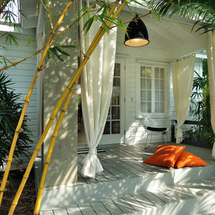 Island style porch idea in Miami with decking and a roof extension