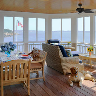 Beach style screened-in porch photo in Boston with decking and a roof extension