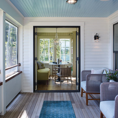 Beach style screened-in porch idea in Portland Maine with decking and a roof extension